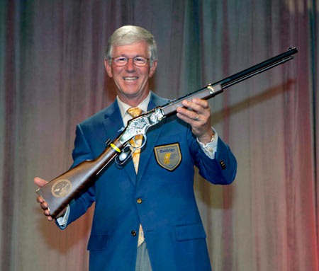 Founder and CEO Larry Potterfield shown with a Boy Scouts of America Centennial Edition Henry Repeating Arms Golden Boy, presented to him by Assistant Chief Scout Executive Brad Farmer (not pictured) Founder and CEO Larry Potterfield shown with a Boy Scouts of America Centennial Edition Henry Repeating Arms Golden Boy, presented to him by Assistant Chief Scout Executive Brad Farmer (not pictured)